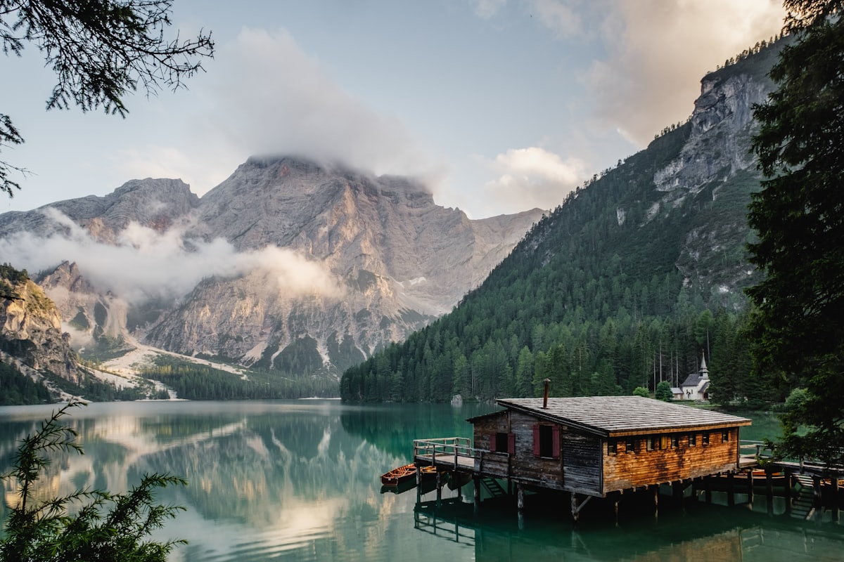 A cabin on a still mountain lake
