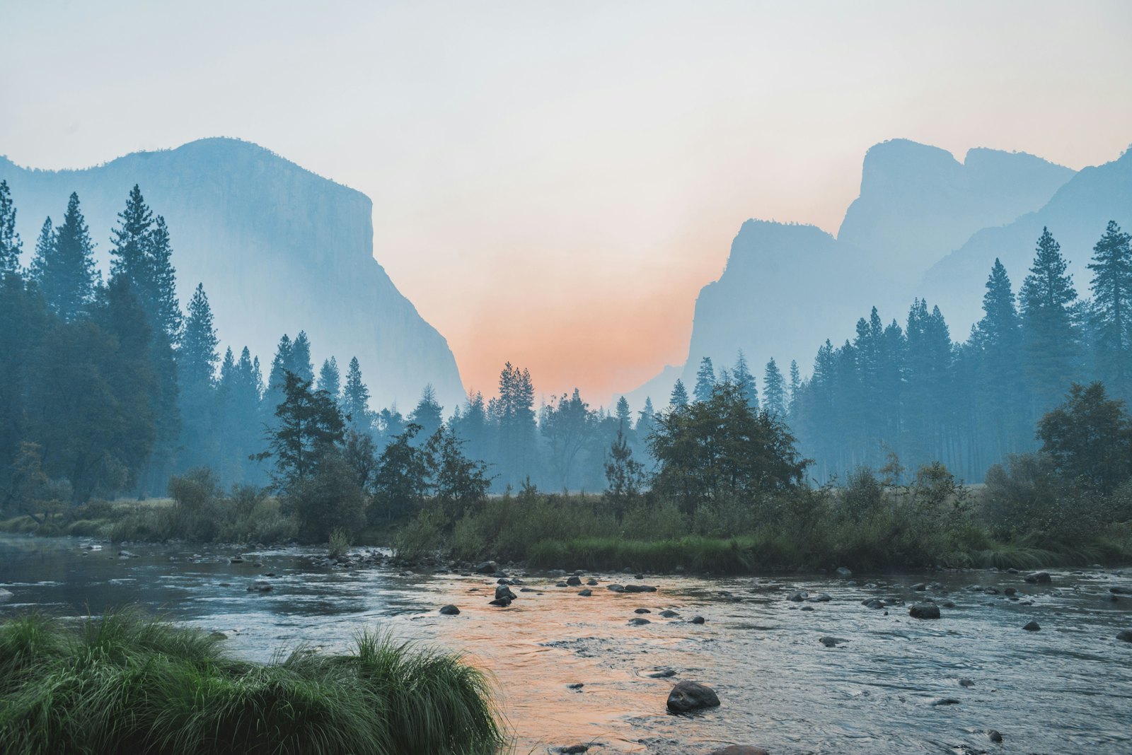 A calm river valley at dusk